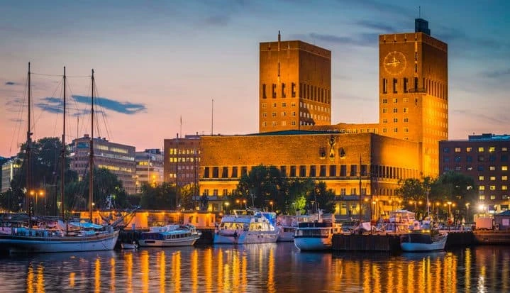 oslo-city-hall-landmark-towers-overlooking-illuminated-harbour