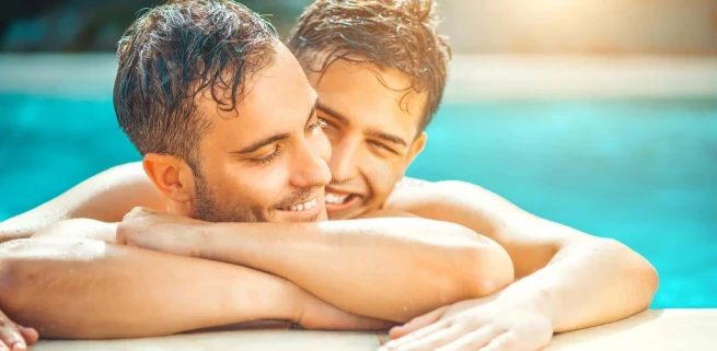gay-couple-relaxing-swimming-pool-lgbt-two-young-men-enjoying-nature-outdoors-kissing-hugging-romantic-family-love-228215579